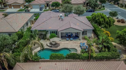 a view of house with backyard and outdoor seating