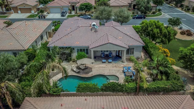 a view of house with backyard and outdoor seating