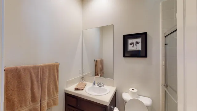 a bathroom with a sink vanity and mirror