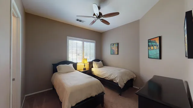 a bedroom with two beds and a window