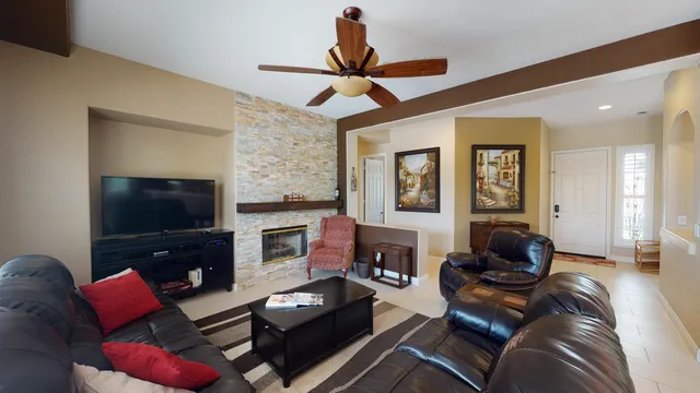 a living room with furniture a flat screen tv and a fireplace