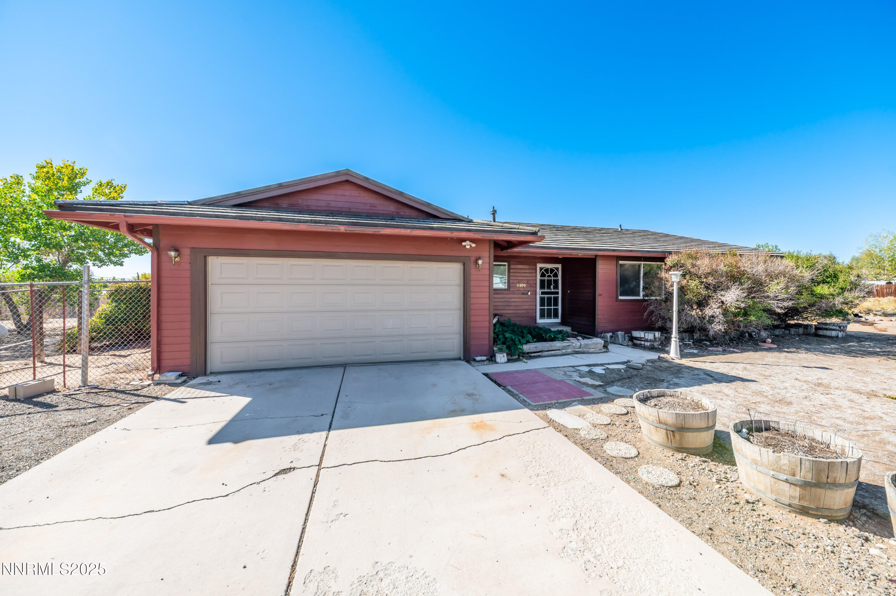 11890 Chesapeake Drive Reno, NV 89506 - Photo 28 of 33 a front view of a house with a yard and garage