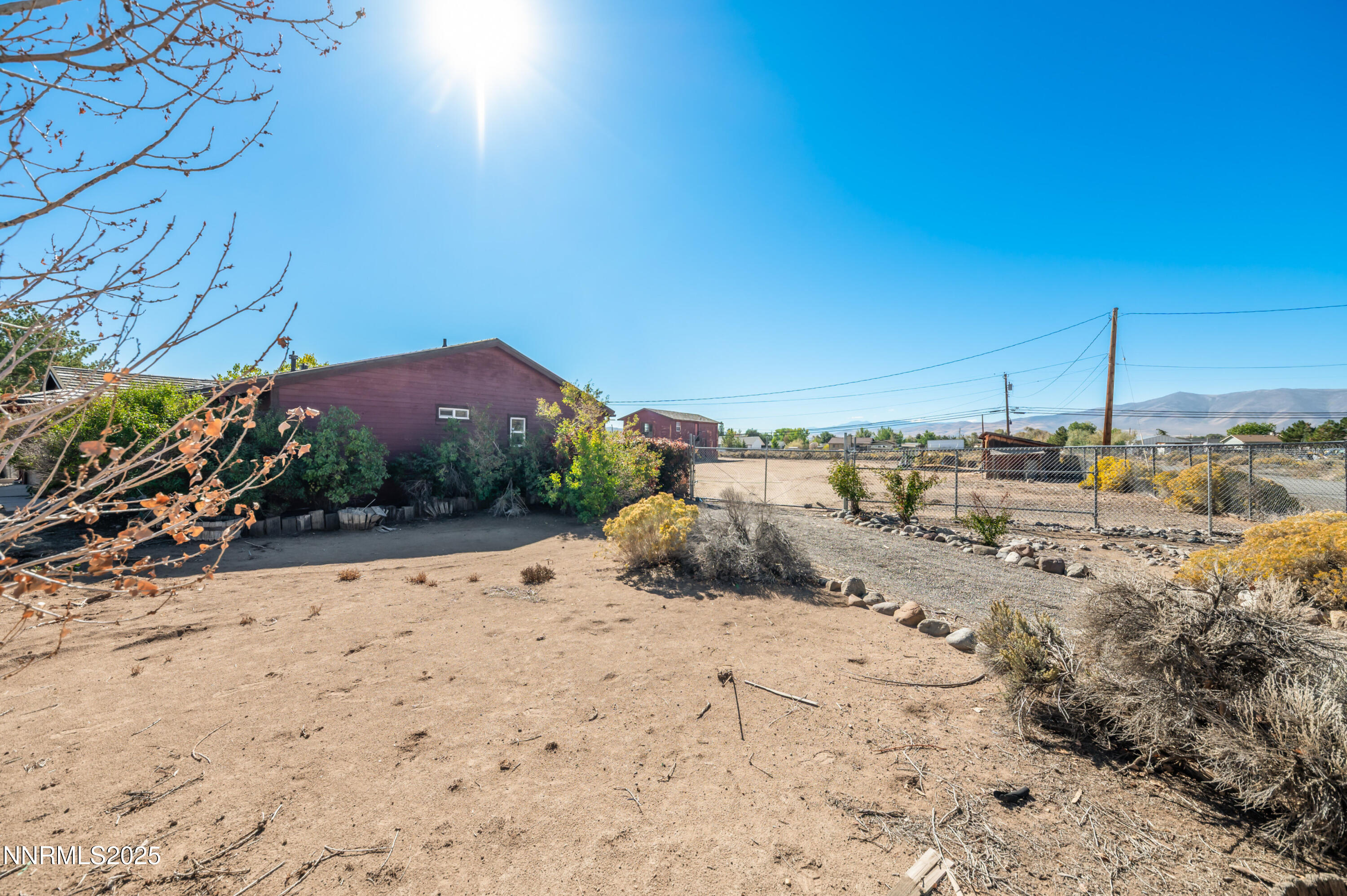 11890 Chesapeake Drive Reno, NV 89506 - Photo 31 of 33 a view of a dry yard covered with snow in the background