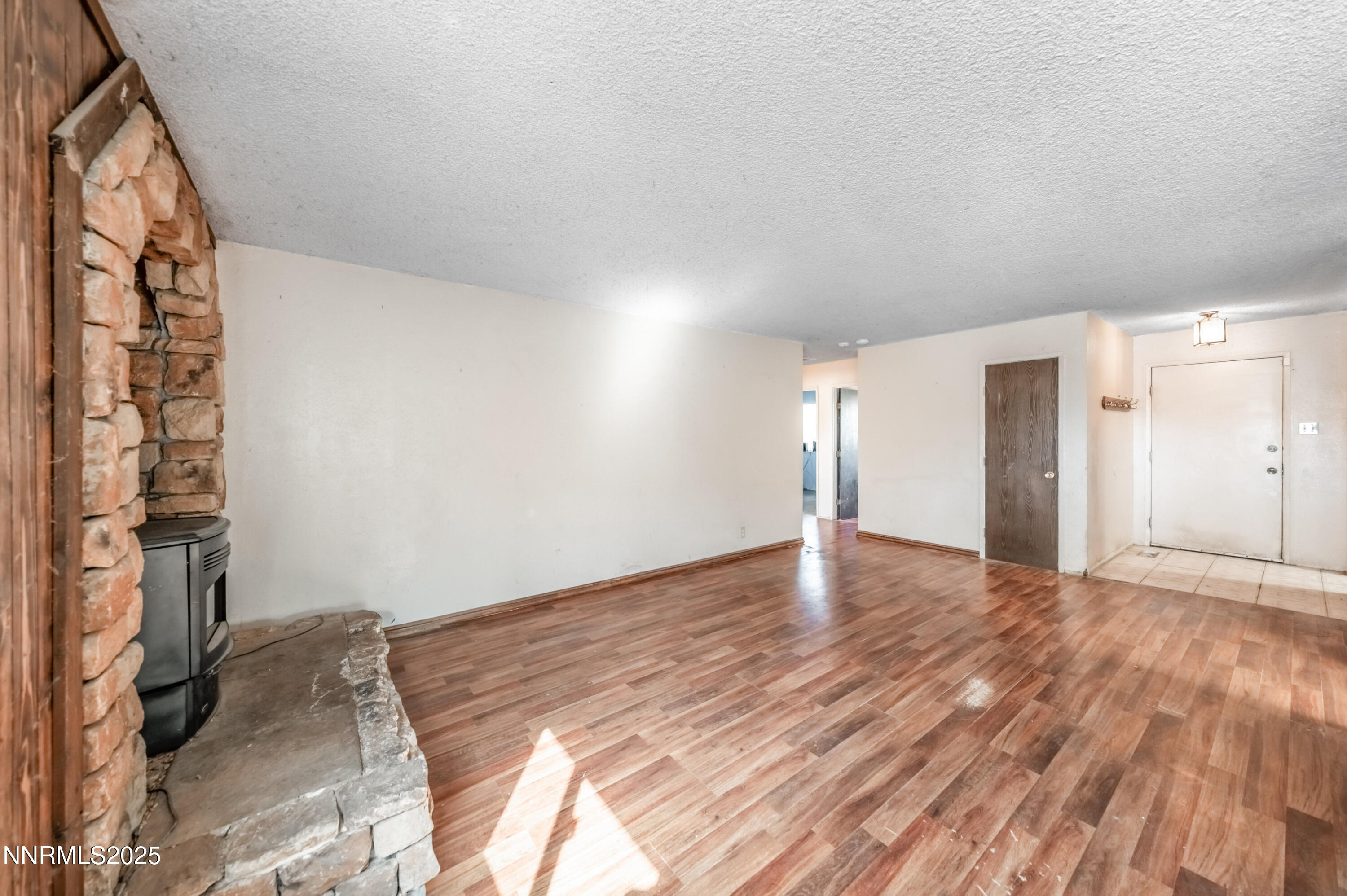 11890 Chesapeake Drive Reno, NV 89506 - Photo 5 of 33 a view of empty room with wooden floor and fan
