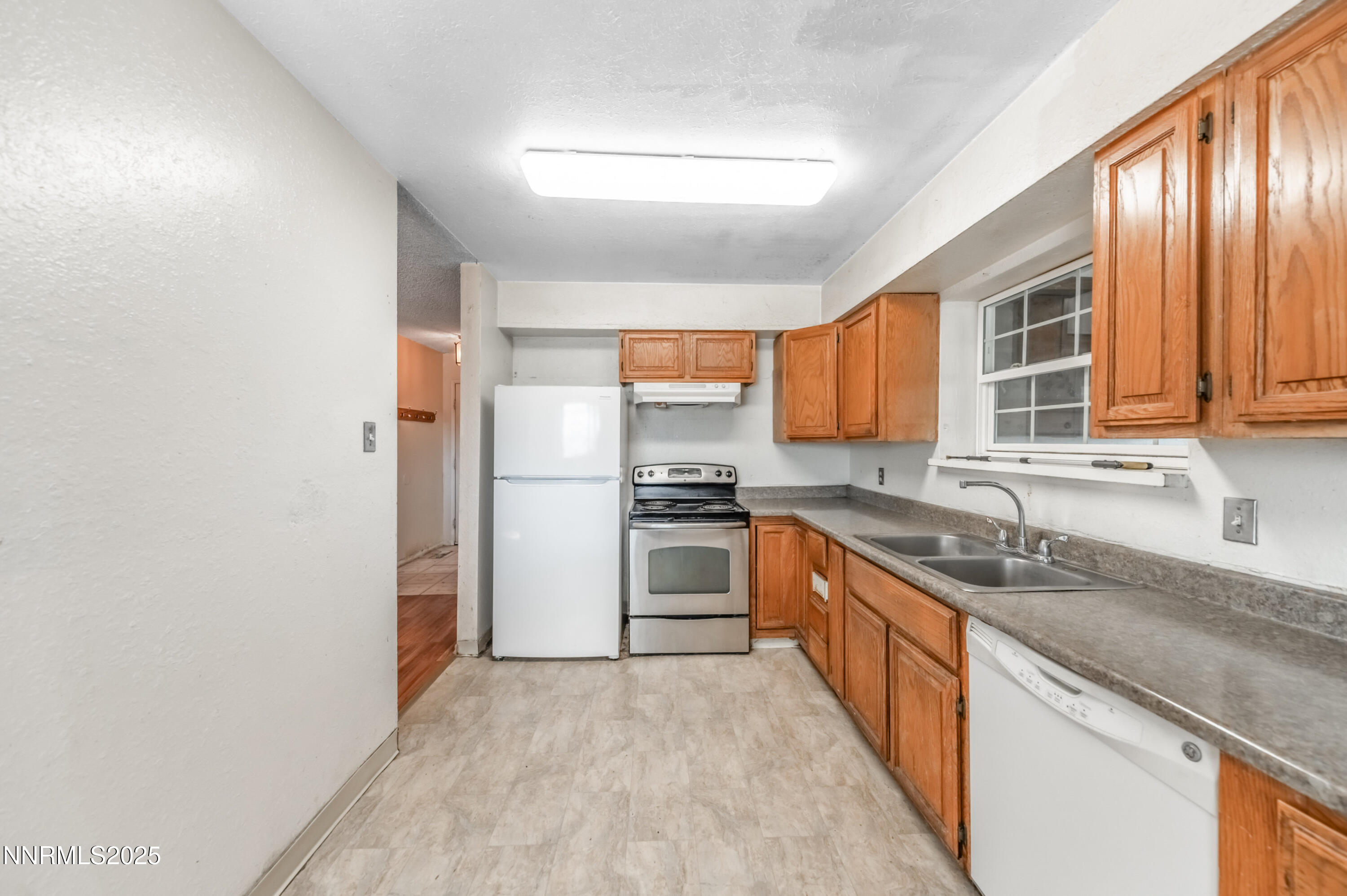 11890 Chesapeake Drive Reno, NV 89506 - Photo 7 of 33 a kitchen with stainless steel appliances granite countertop a stove a sink and a refrigerator