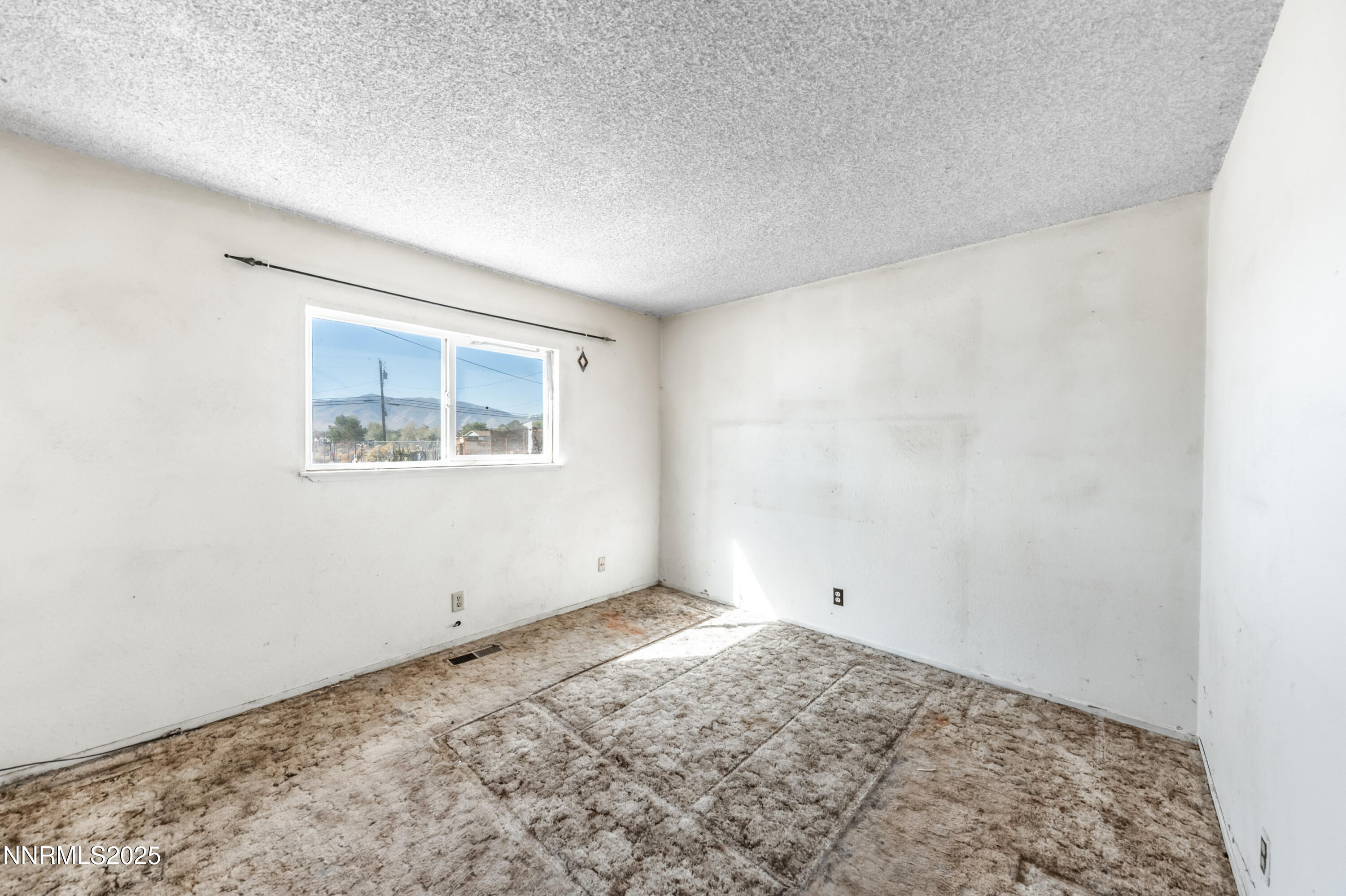 11890 Chesapeake Drive Reno, NV 89506 - Photo 9 of 33 a view of a big room with wooden floor and windows
