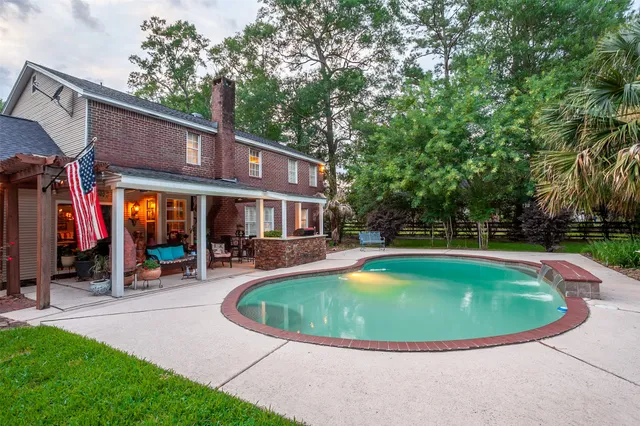 a view of a house with swimming pool and sitting area