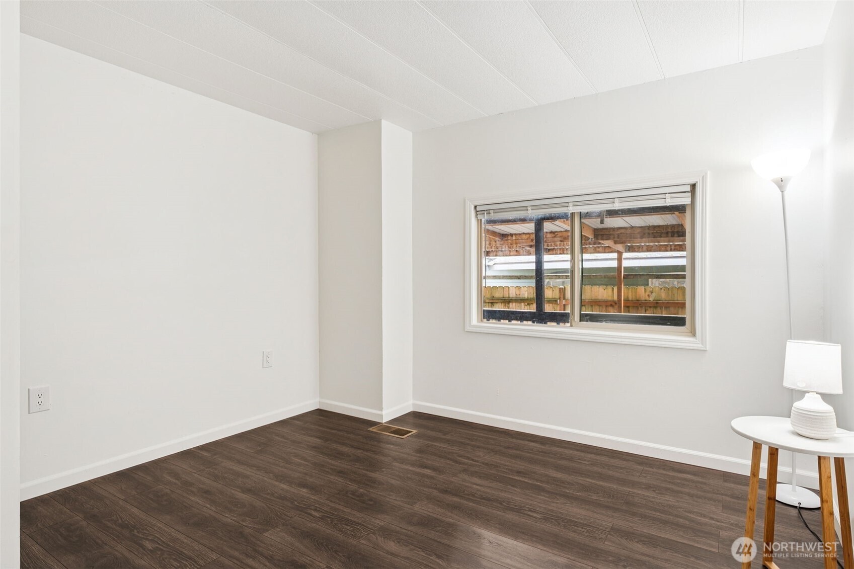 7311 Chambers Creek Road West, Unit 38 University Place, WA 98467 - Photo 8 of 15 a view of an empty room with wooden floor and a window