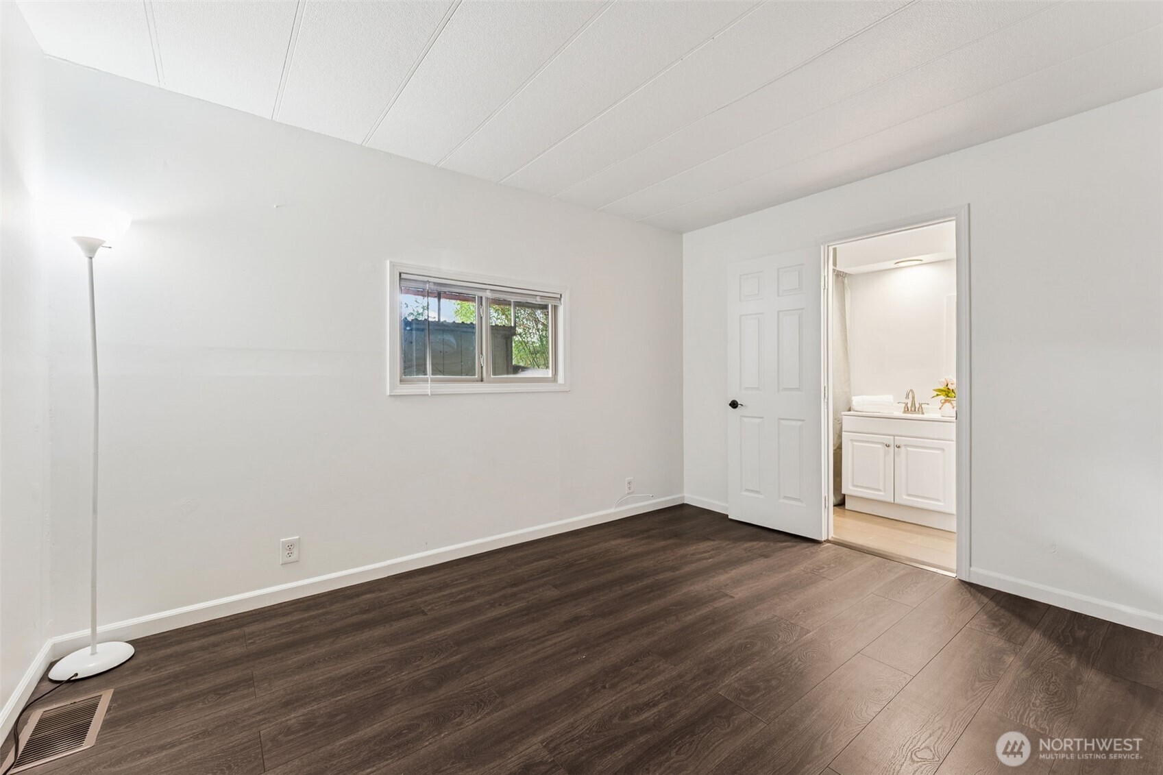 7311 Chambers Creek Road West, Unit 38 University Place, WA 98467 - Photo 10 of 15 a view of an empty room with wooden floor and a window