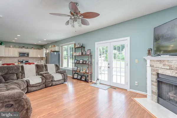 a kitchen with stainless steel appliances granite countertop a refrigerator a stove top oven a sink and dishwasher