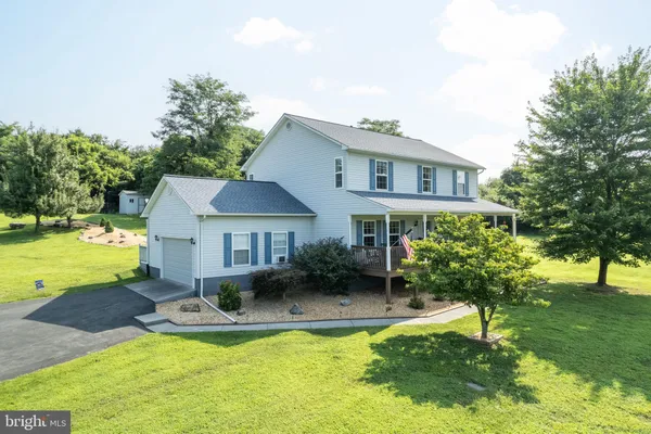 a front view of a house with a yard table and chairs