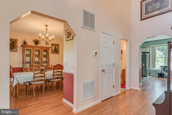 a bathroom with a sink a toilet a mirror and shower