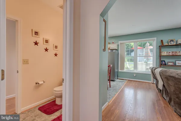 a view of living room with furniture and wooden floor