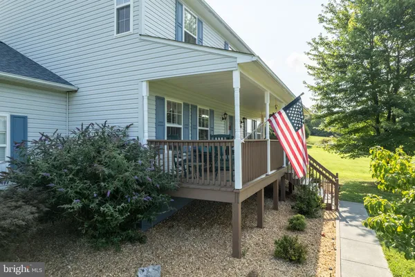 a view of house with a yard and deck