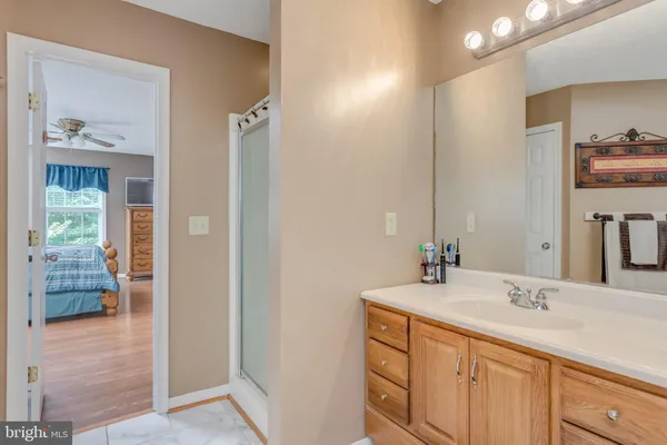 a view of a hallway and wooden floor and a livingroom with furniture