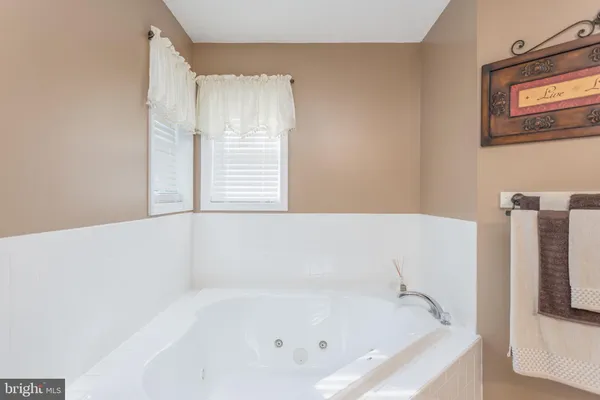 a view of a hallway with wooden floor and closet