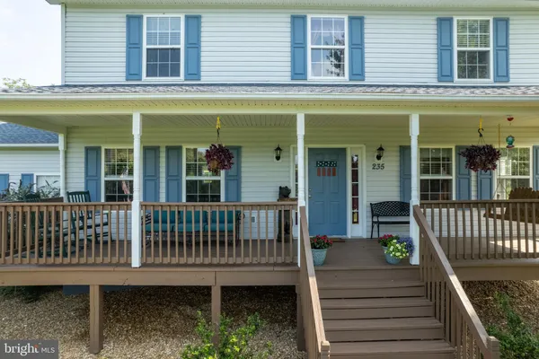 a view of a house with a small yard and wooden floor and a floor to ceiling window