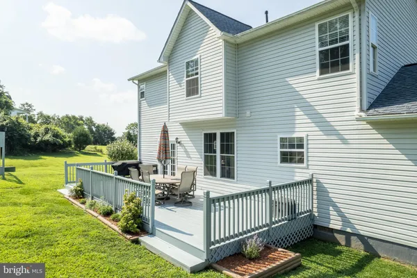 a view of a swimming pool with a patio and a yard