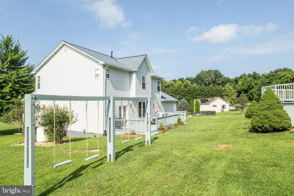 a backyard of a house with yard and outdoor seating