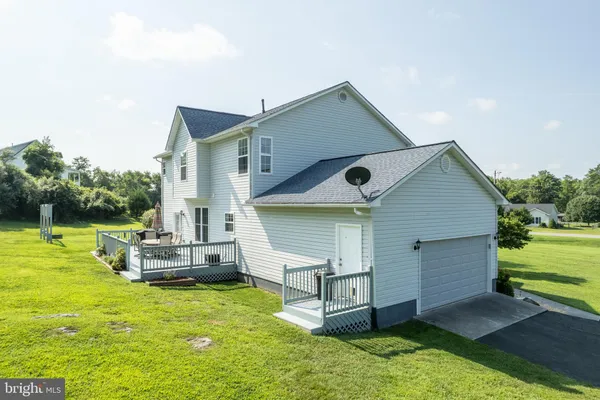 a front view of a house with a big yard