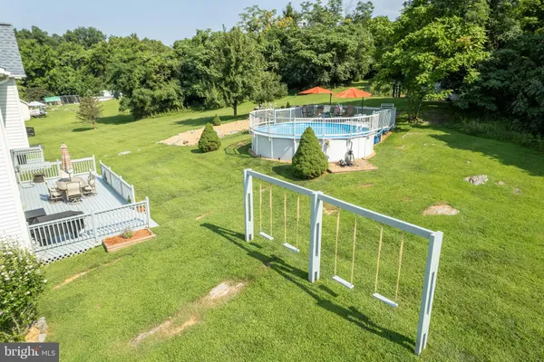 an aerial view of a house with garden space and a lake view
