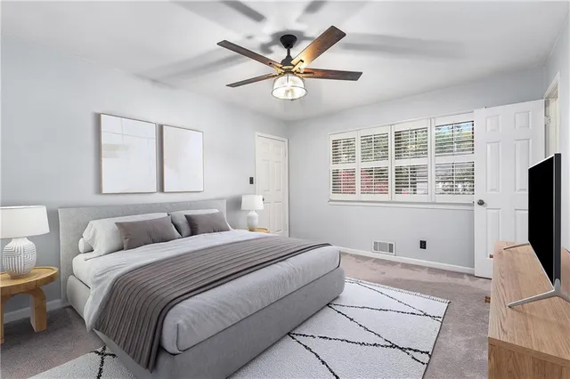 a bedroom with a bed window and a flat screen tv