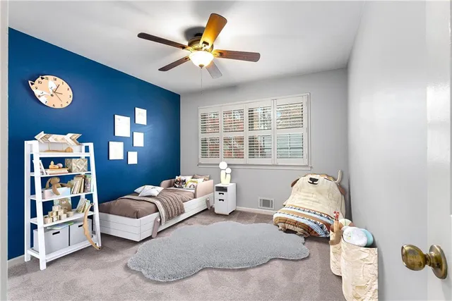 a bedroom with furniture and a large window