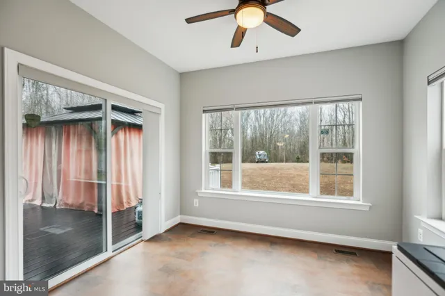 a view of a house with backyard and deck