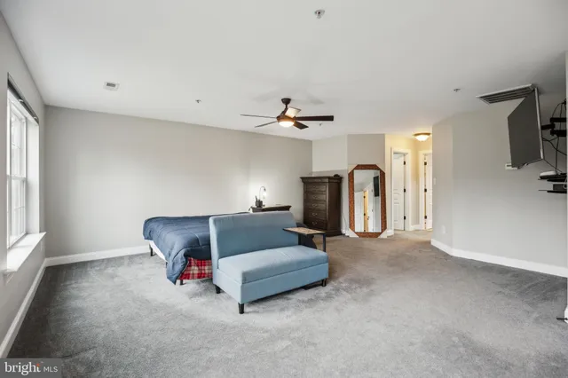 a spacious bedroom with a bed and a window