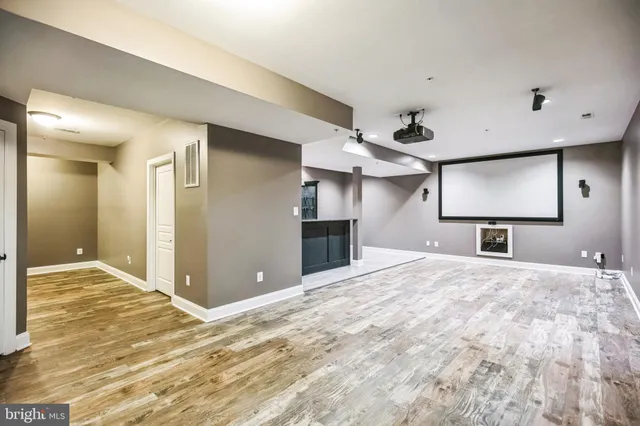 a bathroom with a granite countertop sink a large mirror and shower