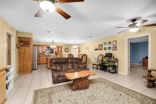 a kitchen with stainless steel appliances granite countertop a refrigerator a stove and a sink