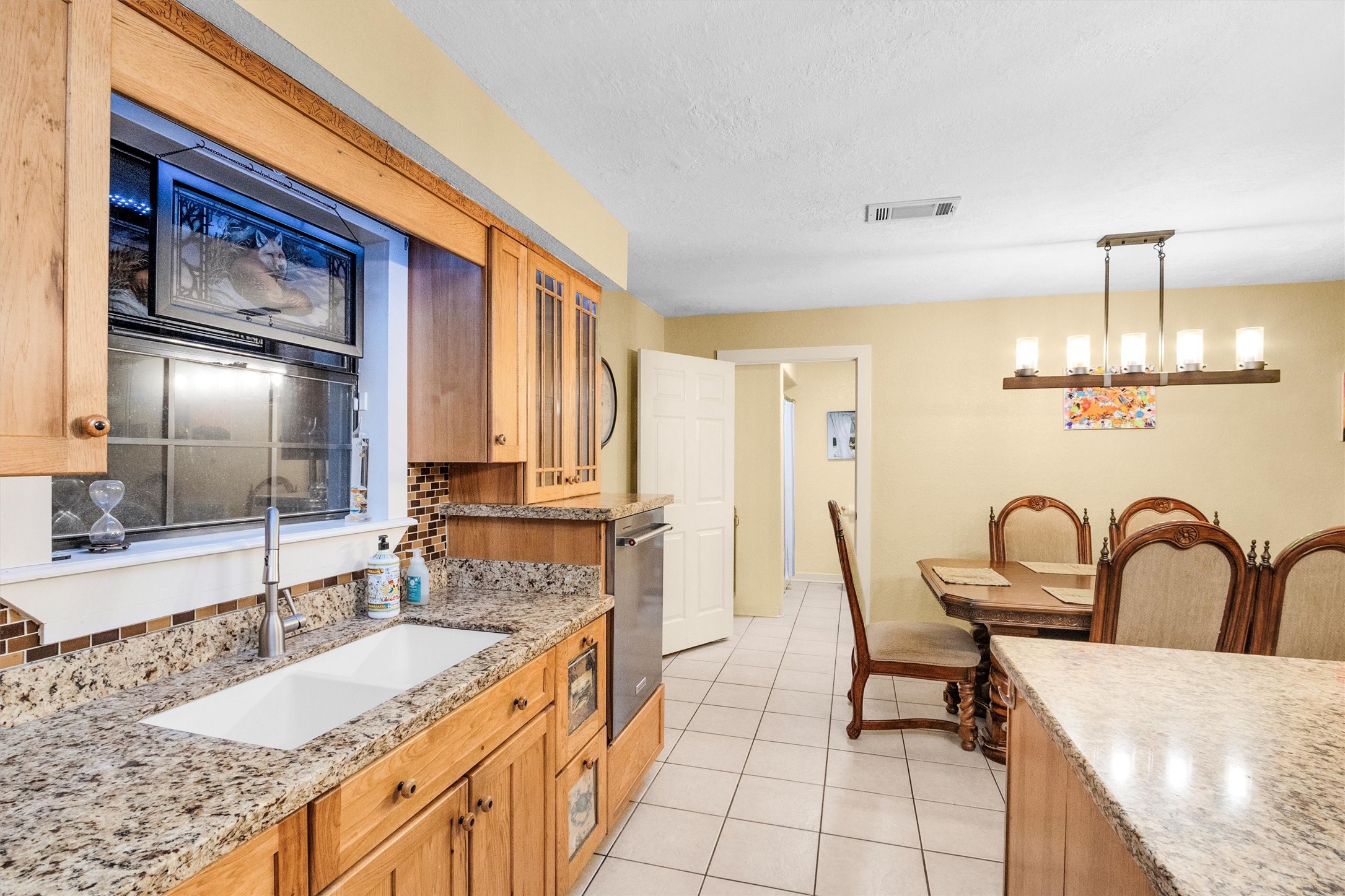 528 Catfish Lane Conroe, TX 77384 - Photo 19 of 49 a large kitchen with kitchen island a large counter space a sink stainless steel appliances and cabinets