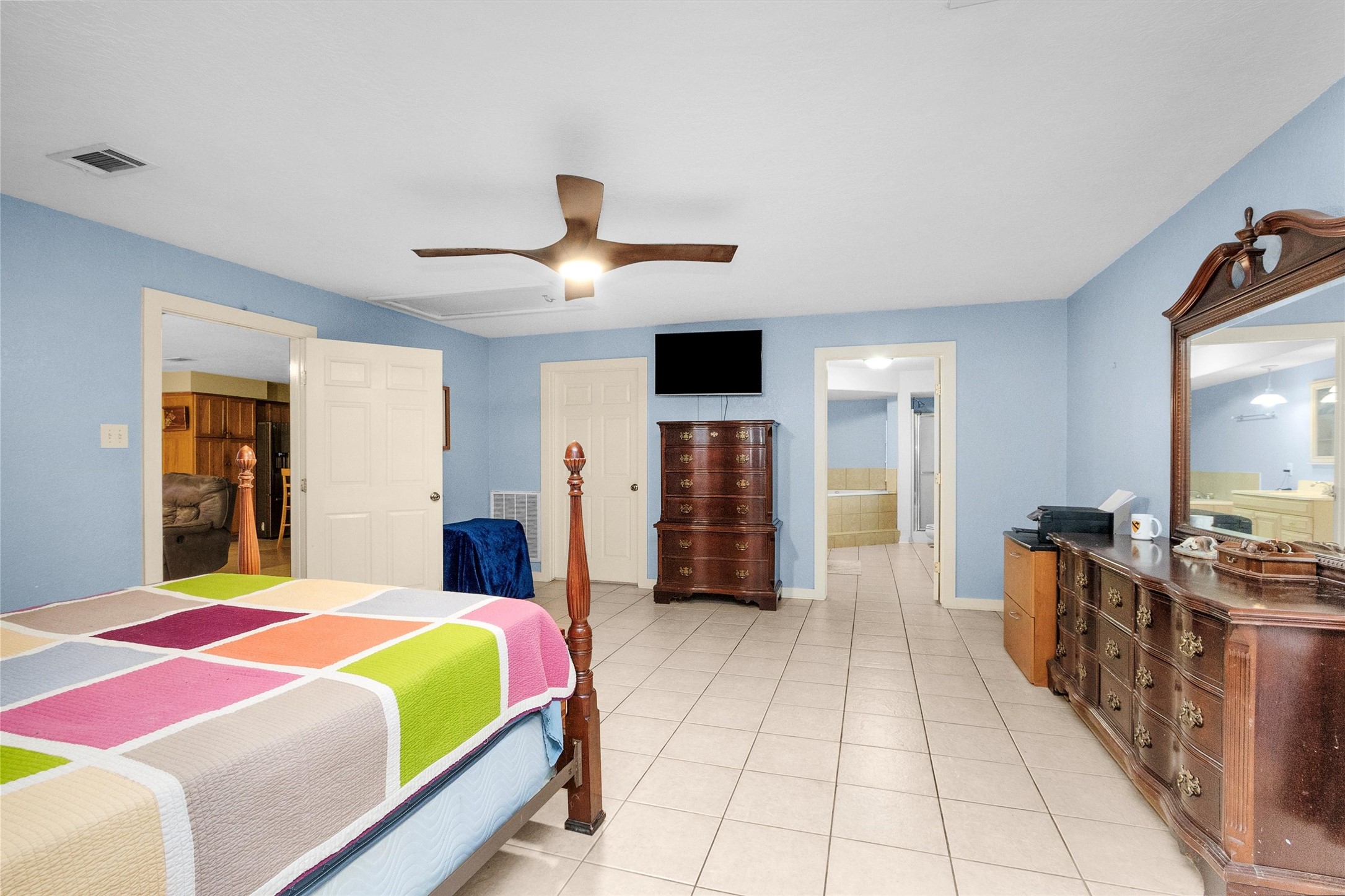 528 Catfish Lane Conroe, TX 77384 - Photo 22 of 49 a spacious bedroom with a bed and a walk in closet