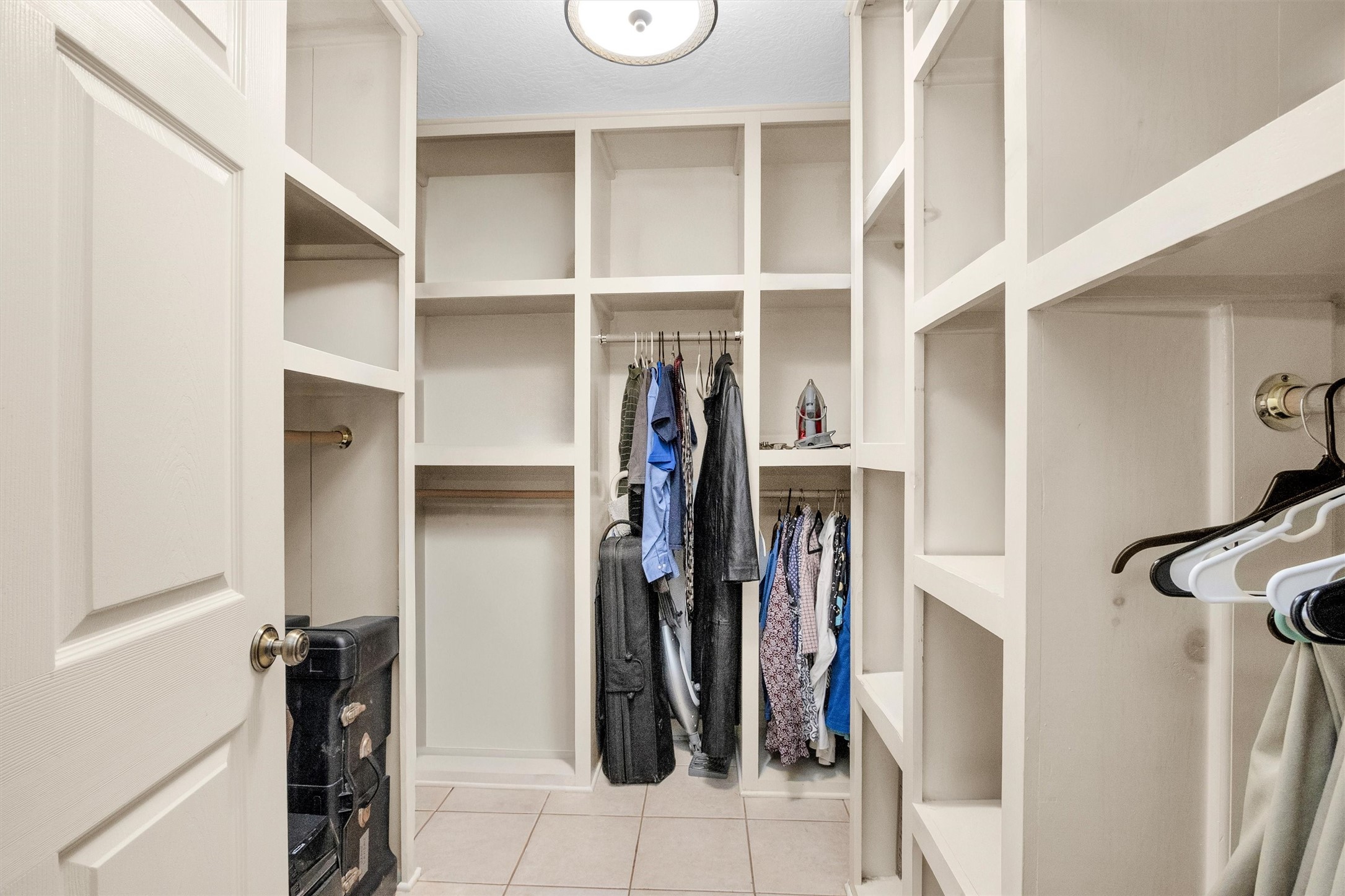 528 Catfish Lane Conroe, TX 77384 - Photo 26 of 49 a view of walk in closet with clothes and shoes