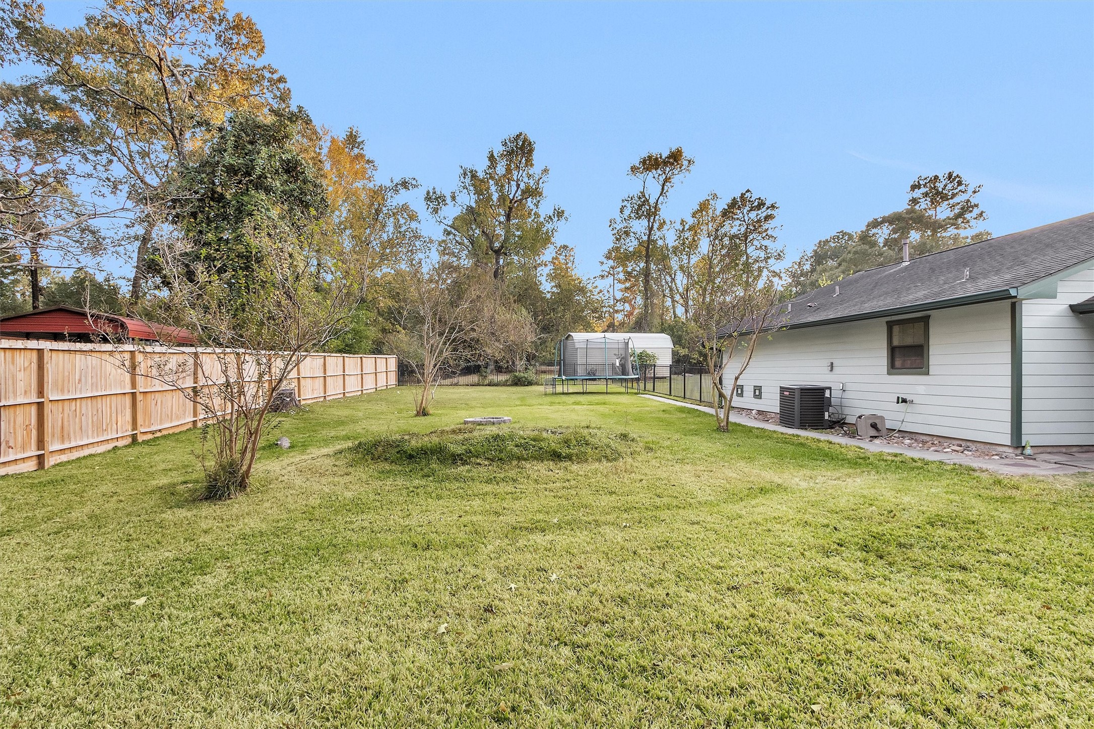 528 Catfish Lane Conroe, TX 77384 - Photo 32 of 49 a backyard of a house with table and chairs