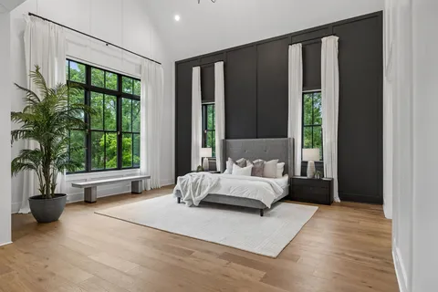 a living room with furniture a fireplace and a floor to ceiling window
