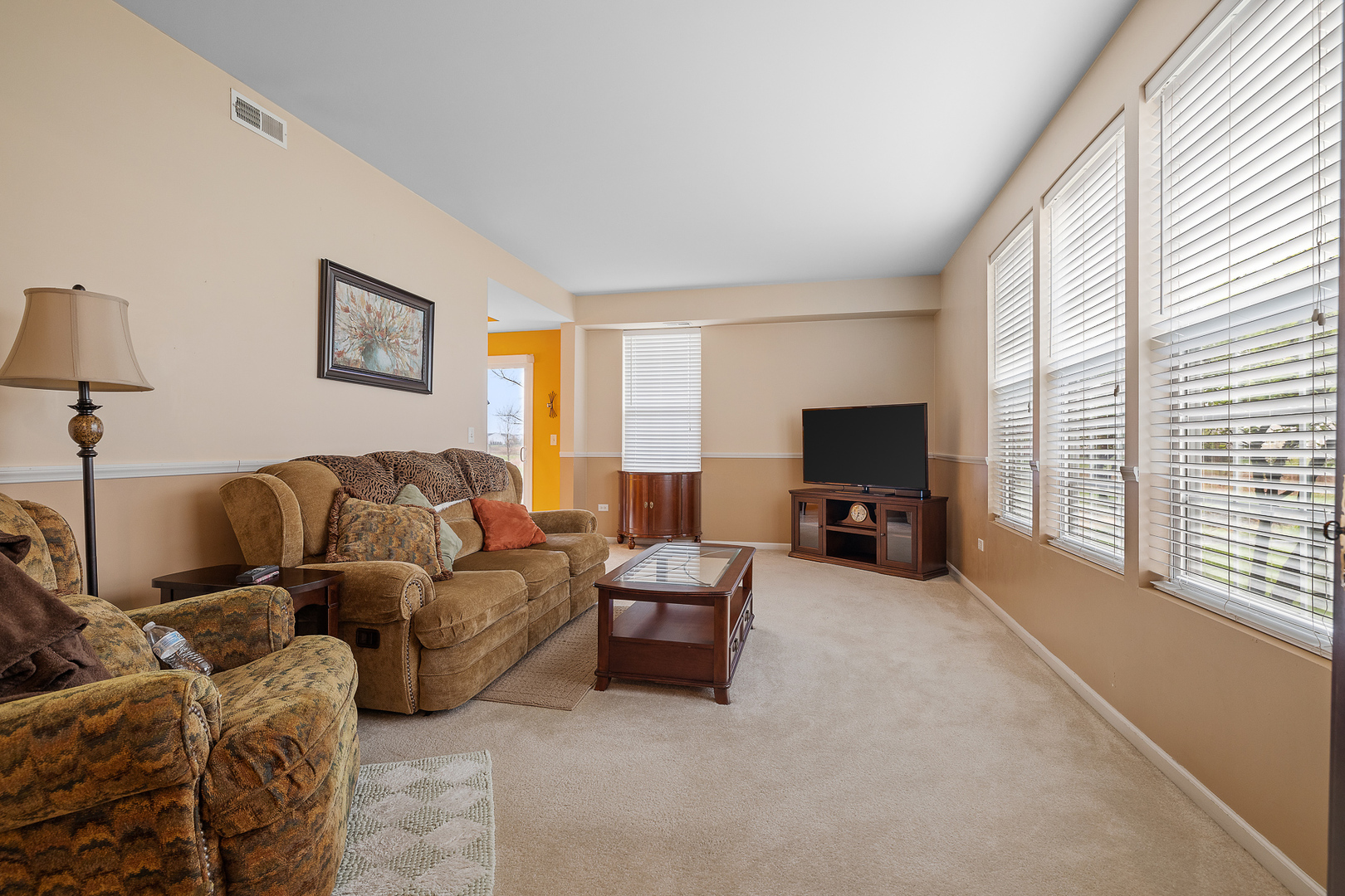 15313 Pinewood Road, Unit 15313 Lockport, IL 60441 - Photo 3 of 15 a living room with furniture and a flat screen tv
