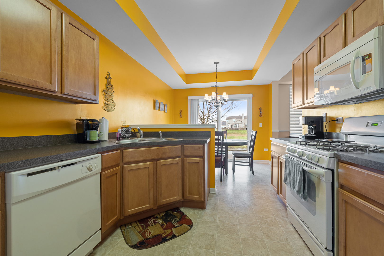 15313 Pinewood Road, Unit 15313 Lockport, IL 60441 - Photo 5 of 15 a kitchen with stainless steel appliances granite countertop a sink and cabinets