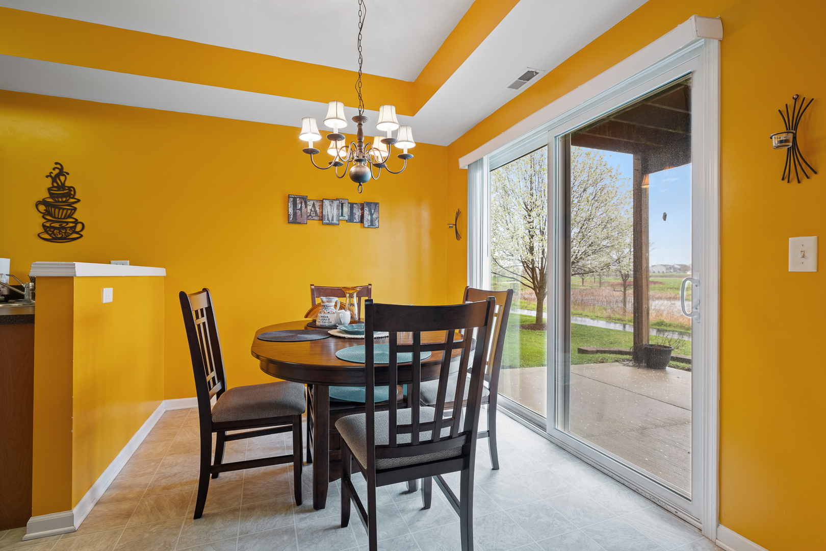 15313 Pinewood Road, Unit 15313 Lockport, IL 60441 - Photo 7 of 15 a view of a dining room with furniture and a chandelier