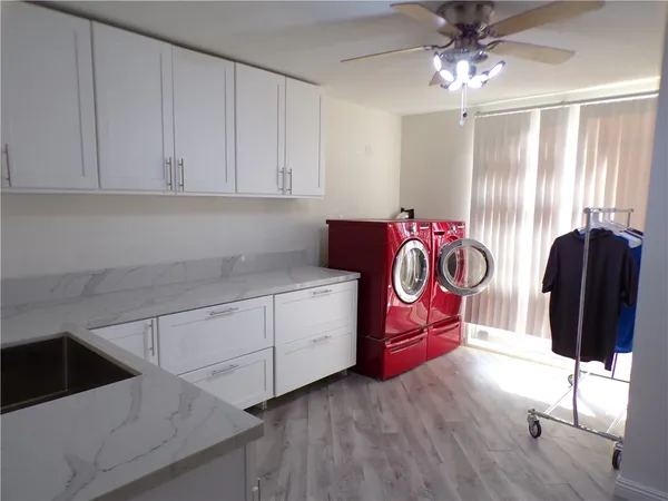 a kitchen with granite countertop a stove a sink and dishwasher with wooden floor