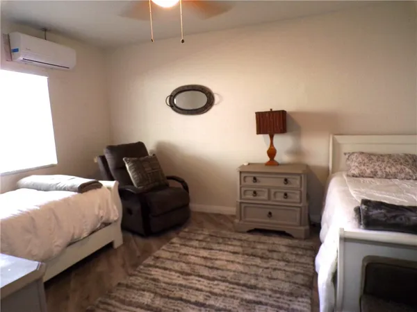 a bedroom with a bed and a chair