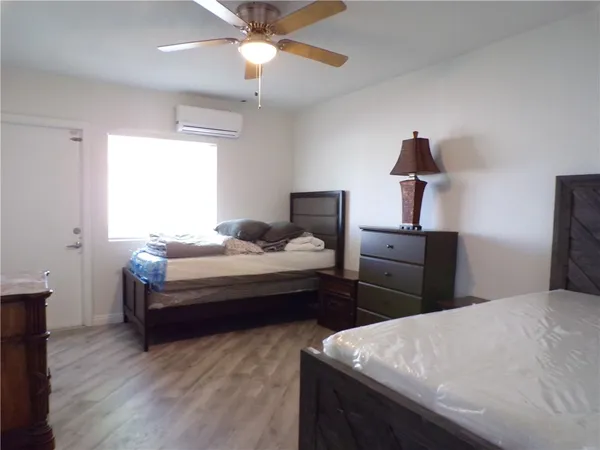 a bedroom with bed and a chandelier
