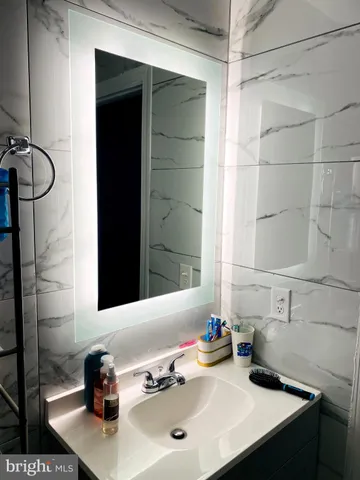 a bathroom with a sink mirror and vanity