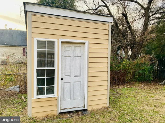 a backyard of a house with table and chairs