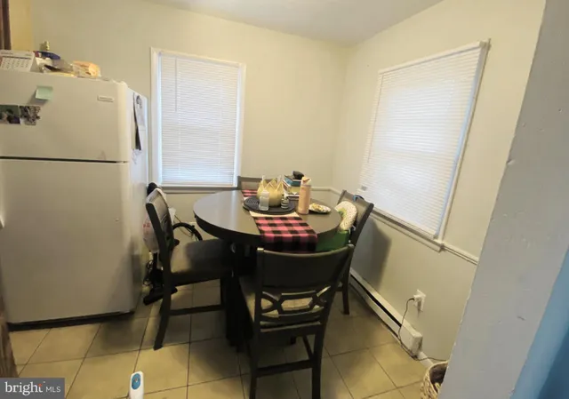 a kitchen with a refrigerator a stove top oven a washer and dryer