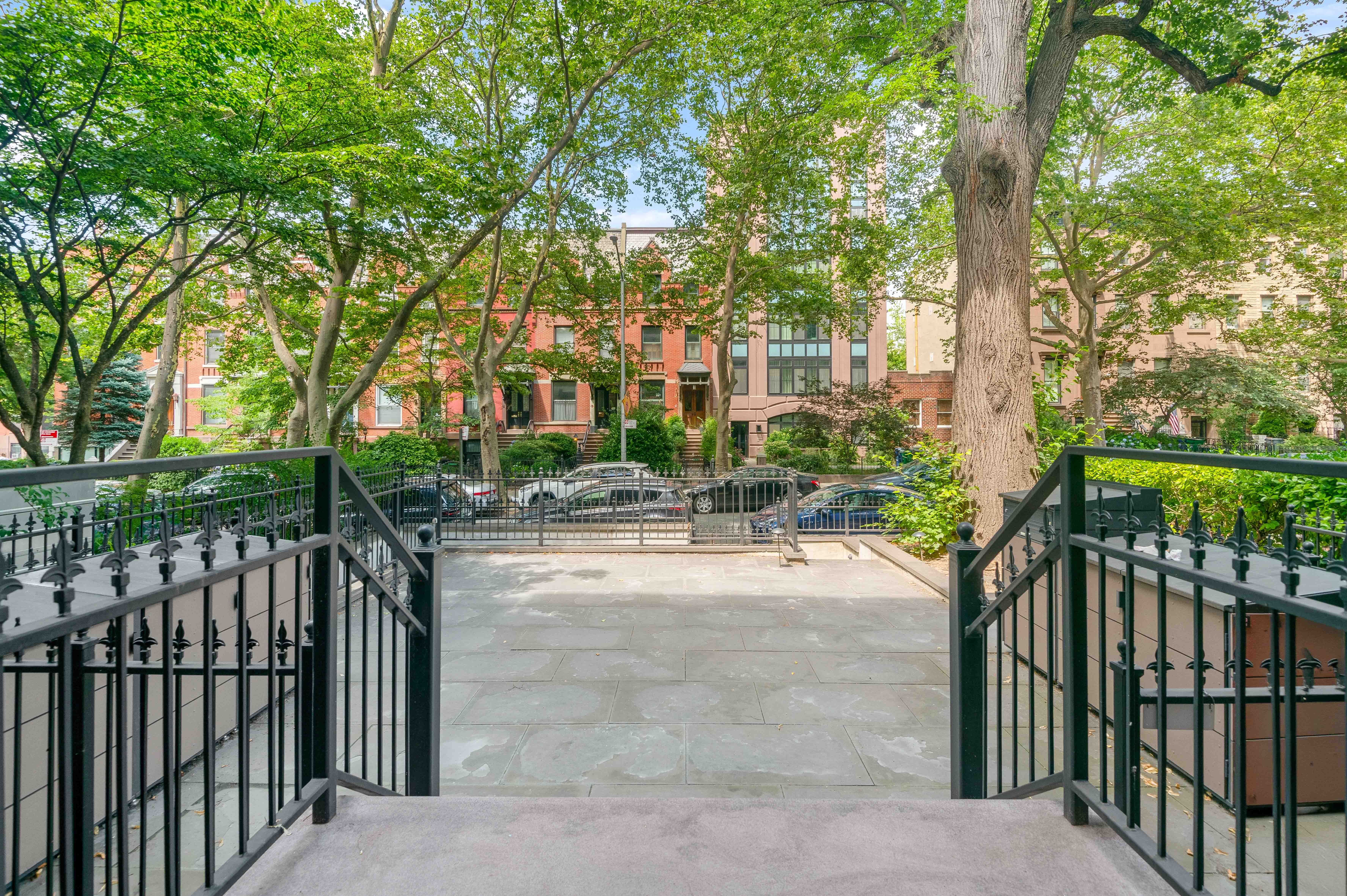 16 2nd Place, Unit RESIDENCE 2 Brooklyn, NY 11231 - Photo 17 of 20 a view of a yard and fountain in front of yellow house