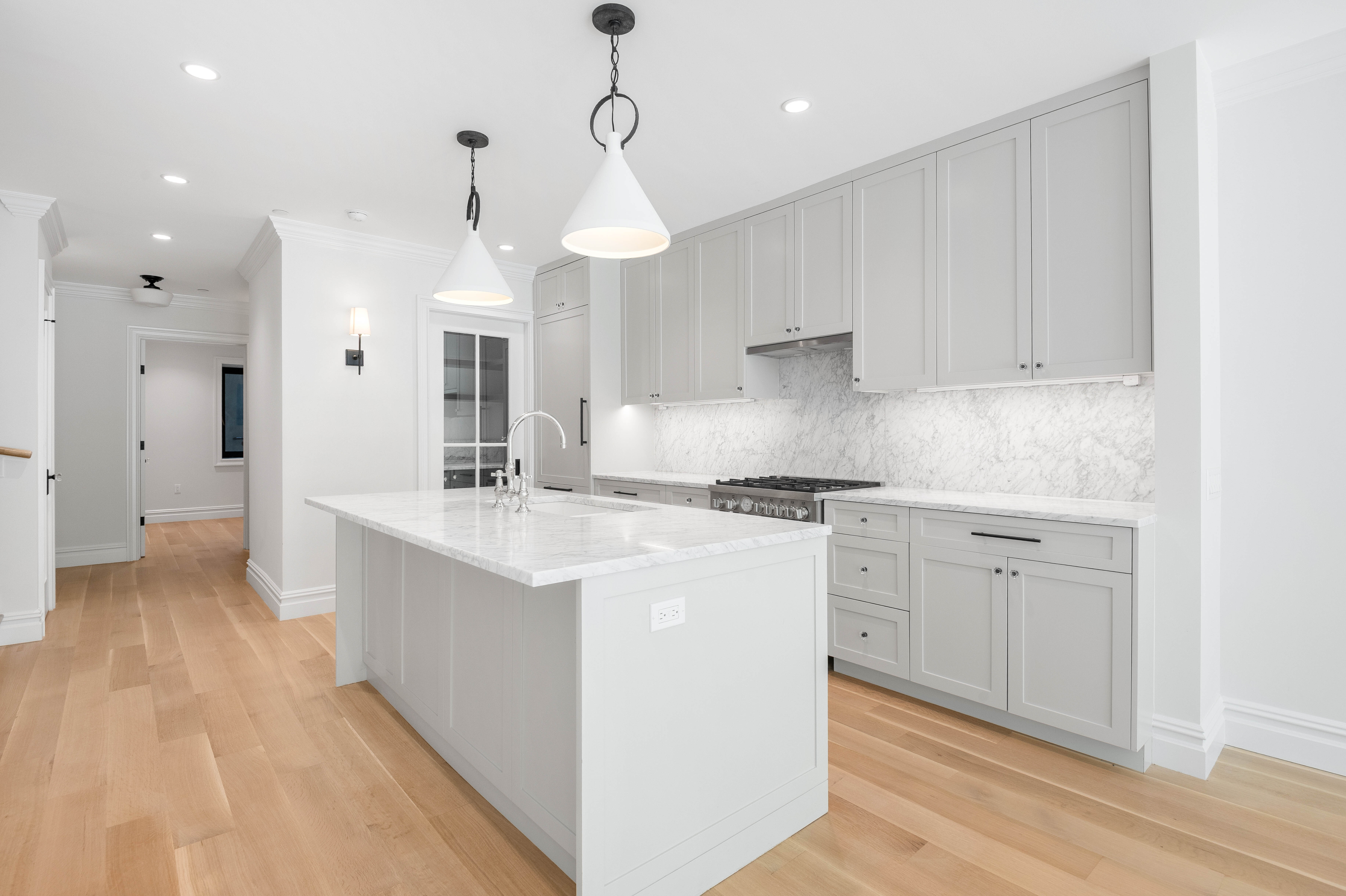 16 2nd Place, Unit RESIDENCE 2 Brooklyn, NY 11231 - Photo 5 of 20 a kitchen with kitchen island white cabinets and white appliances