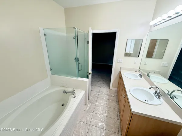 a bathroom with a tub sink and mirror
