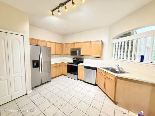 a kitchen with stainless steel appliances granite countertop a refrigerator sink and cabinets