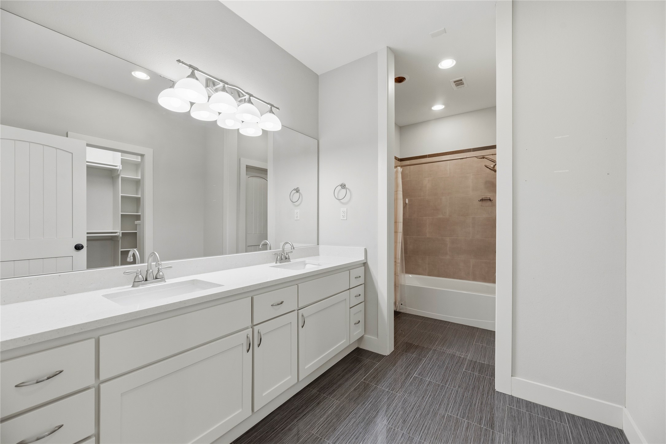 12062 Ike White Road Conroe, TX 77303 - Photo 20 of 37 Primary bathroom is complete with a dual sink vanity, tub/shower combination and walk-in closet.
